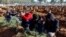 FILE: People react next to graves of victims of the deadly earthquake, in a cemetery in Kahramanmaras, Turkey. Taken Feb. 9, 2023