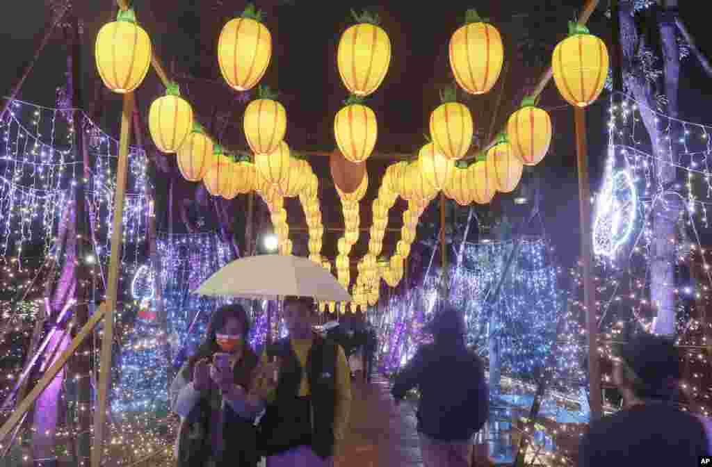 People look at lanterns for the Lantern Festival, marking the end of the Chinese lunar New Year celebrations in Taipei, Taiwan.