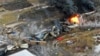 This photo taken with a drone shows portions of a Norfolk and Southern freight train that derailed Friday night in East Palestine, Ohio are still on fire at mid-day Saturday, Feb. 4, 2023. 