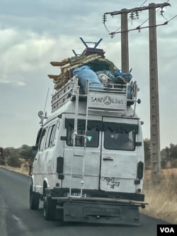 Buses loaded with cargo and farm animals are a common site on Senegal’s roads. (Annika Hammerschlag/VOA)