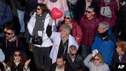 Several thousand health workers hit the streets of Spain's capital to protest the dismantling of Madrid's public health care system by its conservative regional government, Feb. 12, 2023.