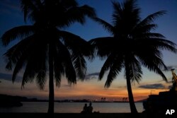 People enjoy the sunset inside what used to be America's largest overseas naval base at the Subic Bay Freeport Zone, Zambales province, northwest of Manila, Philippines on Feb. 6, 2023.