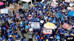 Supporters of South Africa's opposition Democratic Alliance march towards the headquarters of the ruling African National Congress, Johannesburg, Jan 25, 2023