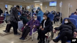 Patients receive intravenous drips in an emergency ward in Beijing, Jan. 19, 2023. 