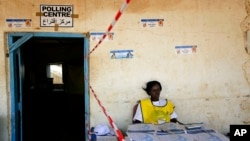 FILE - A South Sudanese election official waits for voters to cast their vote in Juba, South Sudan, Jan. 13, 2011. 