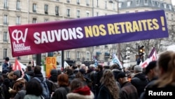 Protesters hold a banner reading "Save our pensions" during a demonstration against the French government's pension reform plan in Paris, France, Jan. 31, 2023.