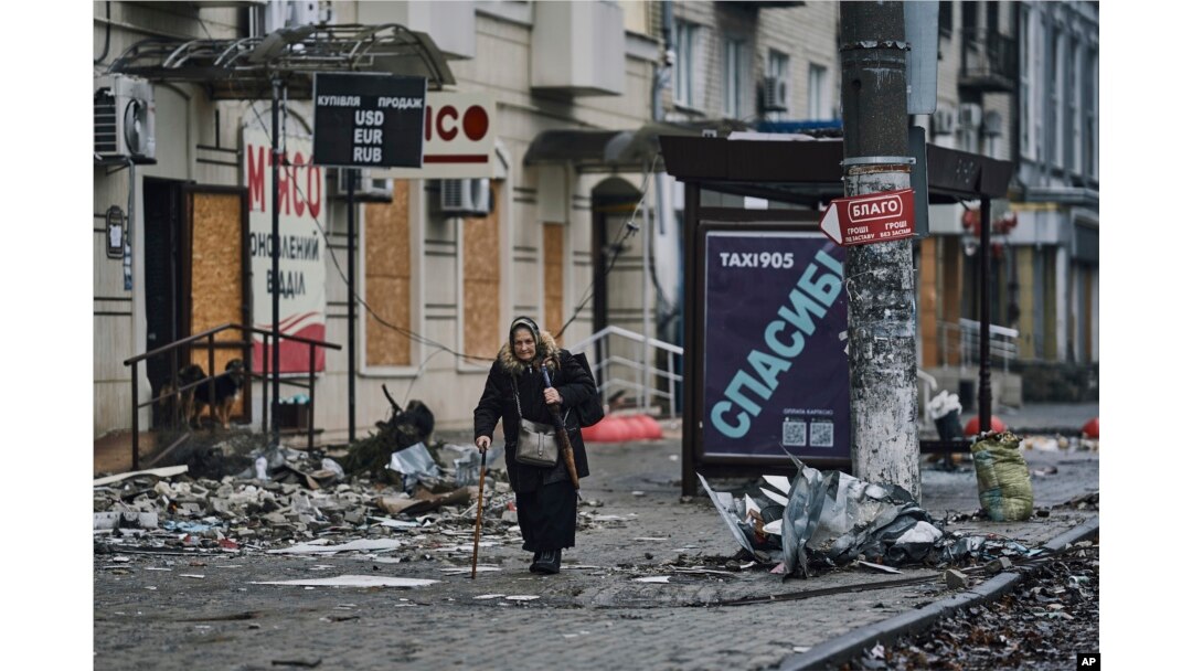 A local resident walks along a street in Bakhmut, in the Donetsk region, Ukraine, Saturday, Dec. 17, 2022. (AP Photo/LIBKOS, File)