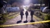 FBI officials walk toward the crime scene at Mountain Mushroom Farm, Jan. 24, 2023, after a gunman killed seven people at two agricultural businesses in Half Moon Bay, California.