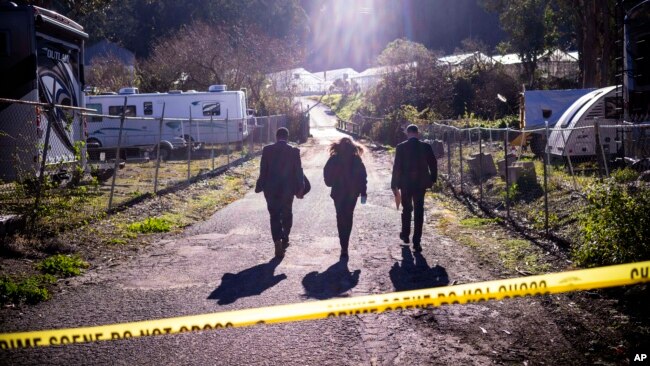 FBI officials walk toward the crime scene at Mountain Mushroom Farm, Jan. 24, 2023, after a gunman killed seven people at two agricultural businesses in Half Moon Bay, California.