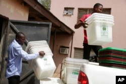 FILE - Electoral workers load ballot boxes into a truck at the local Independent National Electoral Commission office in Yola, Nigeria, Feb. 22, 2019. The INEC office in southeast Anambra state was attacked Feb. 1, 2023, and hundreds of ballot boxes and other election materials were destroyed, members of the election commission said.