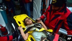 A rescuer takes care of a young girl rescued four days after an earthquake, in Kahramanmaras, southern Turkey, Feb. 10, 2023. 