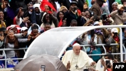 FILE - Pope Francis waves as he arrive to leads a Holy Mass at the Zimpeto stadium in Maputo, on Sept. 6, 2019.