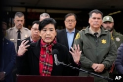 Rep. Judy Chu, D-Calif., left, addresses the media with Los Angeles County Sheriff Robert Luna, right, outside the Civic Center in Monterey Park, Calif., Sunday, Jan. 22, 2023. (AP Photo/Damian Dovarganes)