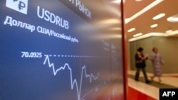FILE - A screen shows the US dollar/ruble exchange rate at the Moscow Exchange office on Jan. 10, 2023.
