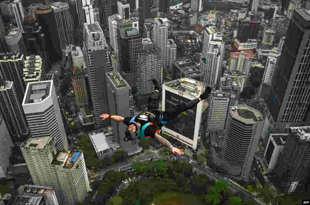 Base jumper Chris Mcdougall of Australia leaps from the 300-meter-high open deck of Malaysia's landmark Kuala Lumpur Tower during the International Tower Jump in Kuala Lumpur.