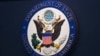 FILE - The State Department seal is seen on the briefing room lectern at the department in Washington, Jan. 31, 2022. 