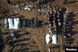 Bodies are lined up at a mass grave, in the aftermath of a deadly earthquake, in Jandaris, northern Aleppo, Syria, Feb. 8, 2023 in this picture obtained from social media. (White Helmets/via Reuters)