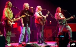 FILE - From left, Stephen Stills, Graham Nash, David Crosby and Neil Young sing Young's "Southern Man" during a concert in Los Angeles, Feb 12, 2000.