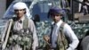 FILE - Houthi fighters stand outside a state security court in Sanaa, Yemen, Feb. 22, 2015.