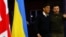 Ukraine's President Volodymyr Zelenskyy and British Prime Minister Rishi Sunak walk, as they hold a news conference at an army camp, in Dorset county, Britain, Feb. 8, 2023. 