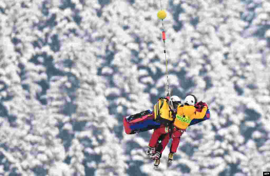 Rescuers of an emergency helicopter transport injured Norway's Henrik Roea, who crashed during the men's downhill competition of the FIS Ski World Cup in Kitzbuehel, Austria.