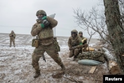 Members of the 3rd Separate Assault Brigade (Azov Unit) of the Armed Forces of Ukraine prepare to fire 152 mm howitzer 2A65 Msta-B, amid Russia's attack on Ukraine, near Bahmut, in Donetsk region, Ukraine, Feb. 6, 2023.