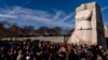 A large group gathers to watch a wreath-laying ceremony at the Martin Luther King Jr. Memorial on Martin Luther King Jr. Day in Washington, Jan. 16, 2023.