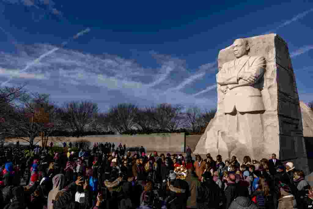 People gather to watch a wreath-laying ceremony at the Martin Luther King Jr. Memorial on Martin Luther King Jr. Day in Washington.