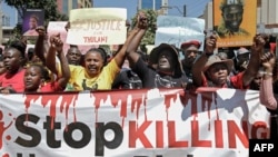 FILE - Members of various human rights Defender groups protest the brutal killing of renowned human rights lawyer Thulani Maseko at his home in Eswatini in Nairobi, Kenya, on Jan. 30, 2023. 