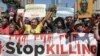 FILE - Members of various human rights Defender groups protest the brutal killing of renowned human rights lawyer Thulani Maseko at his home in Eswatini in Nairobi, Kenya, on Jan. 30, 2023. 