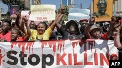 FILE - Members of various human rights Defender groups protest the brutal killing of renowned human rights lawyer Thulani Maseko at his home in Eswatini in Nairobi, Kenya, on Jan. 30, 2023. 