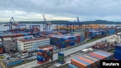 FILE - A general view shows the port in Vladivostok, Russia, Sept. 5, 2022. After nearly a year of heavy sanctions, the Russian economy has rebounded as importers found new avenues of trade to bring products into the country.