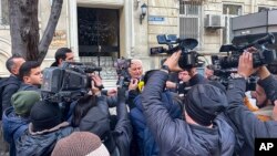 Journalists gather in front of the Iranian Embassy in Baku, Azerbaijan, Jan. 27, 2023.