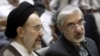 FILE - Mohammad Khatami (L) and Mir Hossein Mousavi attend a memorial service at a mosque in Tehran, Iran, July 31, 2009.