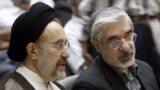 FILE - Mohammad Khatami (L) and Mir Hossein Mousavi attend a memorial service at a mosque in Tehran, Iran, July 31, 2009.