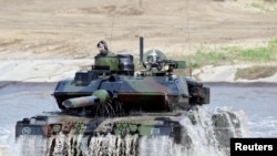 FILE: A Leopard 2 tank is seen during a visit of then German Chancellor Angela Merkel to NATO's new spearhead force "VJTF 2019" in Munster, May 20, 2019. 