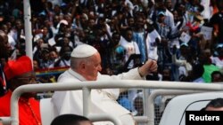 FILE: Pope Francis gestures from a vehicle before addressing the youth at the Martyrs Stadium, in Kinshasa, Democratic Republic of the Congo on Thursday Feb. 2, 2023.