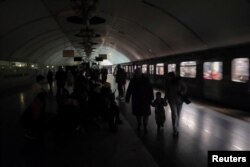 FILE - People shelter inside a metro station during partial power outage amid massive Russian missile attacks in Kyiv, Ukraine, Dec. 16, 2022.