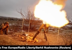Ukrainian servicemen fire a mortar toward Russian positions on a frontline near the town of Soledar in Donetsk region, Ukraine, Jan. 14, 2023.
