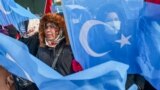 FILE - People from China's Uyghur Muslim ethnic group protest outside the city's Turkish Olympic Committee building, calling for a boycott of next month's Winter Olympics, in Istanbul, Turkey, Jan. 23, 2022. 