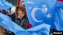 FILE - People from China's Uyghur Muslim ethnic group protest outside the city's Turkish Olympic Committee building, calling for a boycott of next month's Winter Olympics, in Istanbul, Turkey, Jan. 23, 2022. 