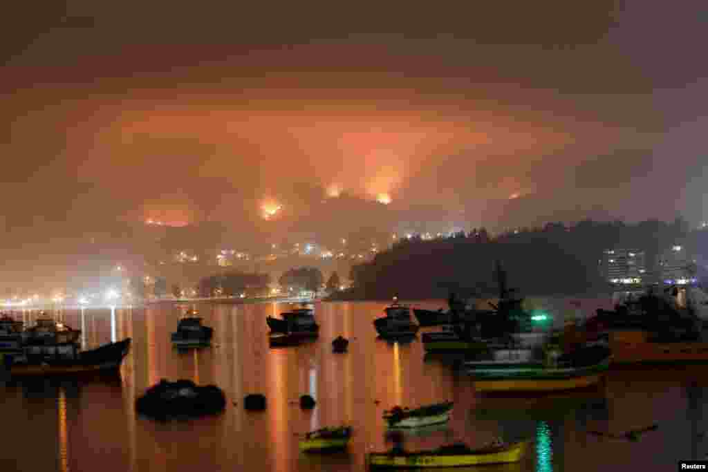 A wildfire burns areas in Dichato, near Concepcion, Chile.&nbsp;Firefighters were battled dozens of raging wildfires, seeking to gain control of one of the country&#39;s worst natural disasters in years as the death toll rose to at least 24 with nearly 1,000 more injured.