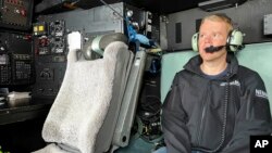 New Zealand's Prime Minister Chris Hipkins sits in a military plane Jan. 28, 2023, bound for Auckland to assess weather damage. Torrential rain and flooding continued to cause widespread disruption to New Zealand's largest city.