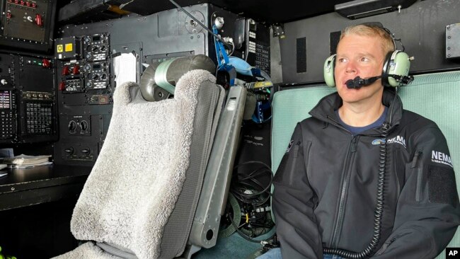 New Zealand's Prime Minister Chris Hipkins sits in a military plane Jan. 28, 2023, bound for Auckland to assess weather damage. Torrential rain and flooding continued to cause widespread disruption to New Zealand's largest city.