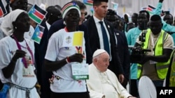 Pope Francis (C-R), seated on a wheelchair, arrives for a meeting with internally displaced persons at the Freedom Hall in Juba, South Sudan, on Feb. 4, 2023.