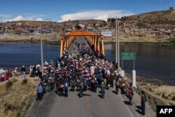 Members of Aymara communities hold a blockade on the Ilave International Bridge to protest the government of Peruvian President Dina Boluarte in Ilave, Puno, Peru, Jan. 16, 2023.