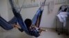 Yanomami indigenous children being treated for malnutrition lie on hammocks with their father at the special ward for indigenous people of the Santo Antonio Children's Hospital in Boa Vista, Brazil, Jan. 27, 2023.