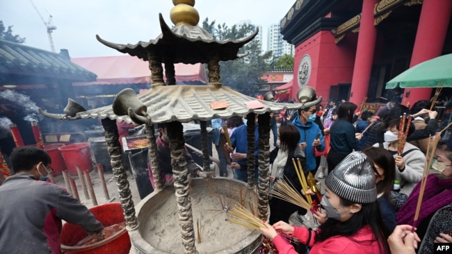 Worshippers burn joss sticks at the Che Kung temple on the fourth day of the Lunar New Year in Hong Kong on Jan. 25, 2023, as people flocked to temples to pray for good luck and fortune for the Year of the Rabbit.