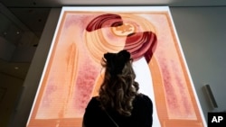 A visitor looks at artist Refik Anadol's "Unsupervised" exhibit at the Museum of Modern Art, Jan. 11, 2023, in New York.