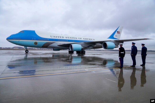 Military officers look on as Air Force One, with President Joe Biden, prepares for takeoff Jan. 31, 2023, en route to New York. (AP Photo/Jess Rapfogel)